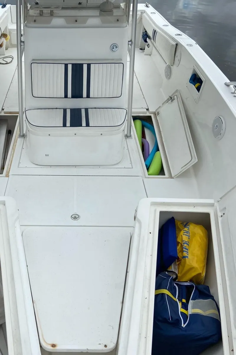 Slide: The Image of 2000 Stamas 290 Tarpon boat interior with storage compartments open. - 6