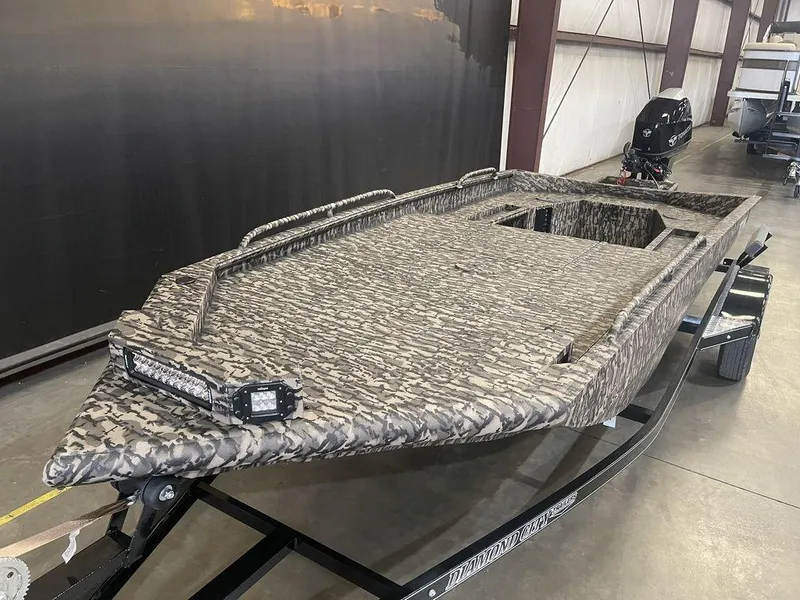 Slide: The Image of 2023 Legend Craft Outlaw 1656 boat in camouflage pattern on a trailer. - 10