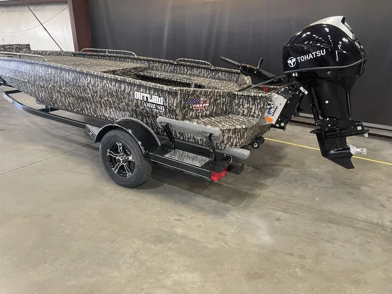 Slide: The Image of 2023 Legend Craft Outlaw 1656 boat with Tohatsu outboard motor on trailer. - 14