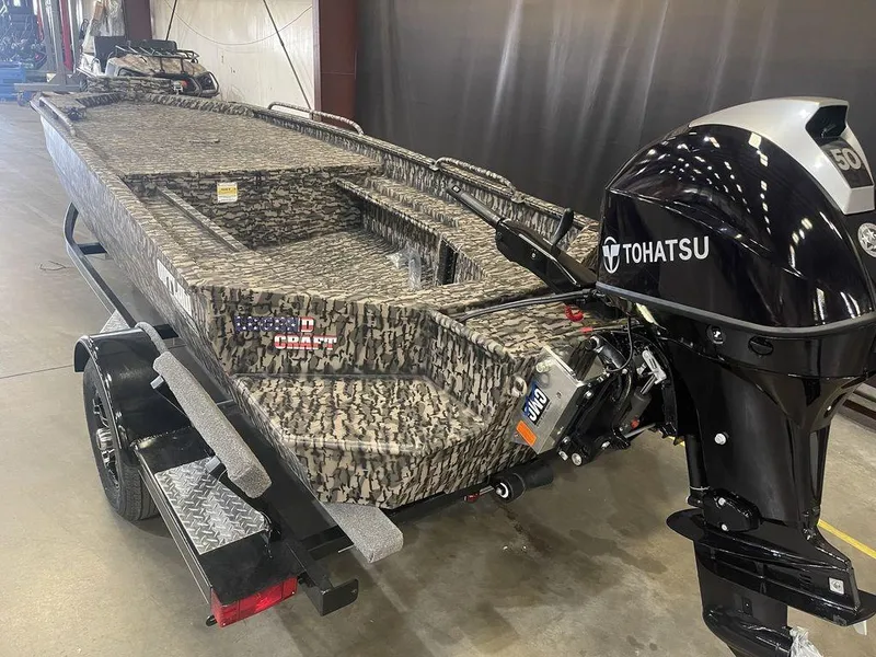 Slide: The Image of 2023 Legend Craft Outlaw 1656 boat with Tohatsu outboard motor in a showroom. - 16