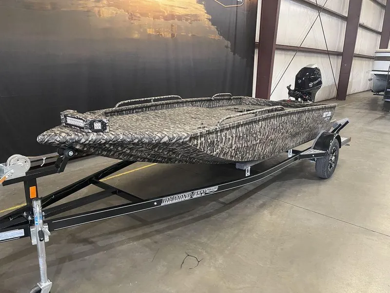 Slide: The Image of 2023 Legend Craft Outlaw 1656 boat in showroom, camo design, on trailer. - 4