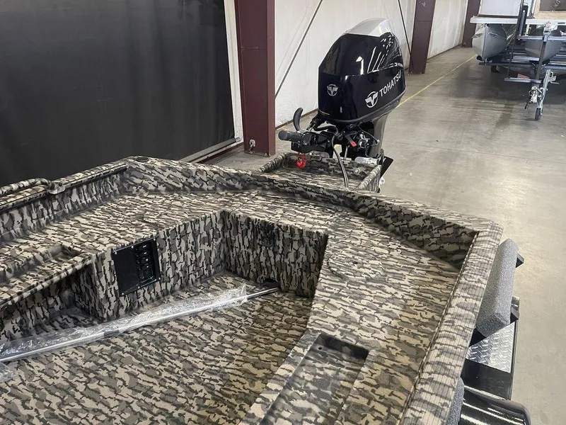 Slide: The Image of 2023 Legend Craft Outlaw 1656 boat with camo interior and Tohatsu outboard motor. - 8