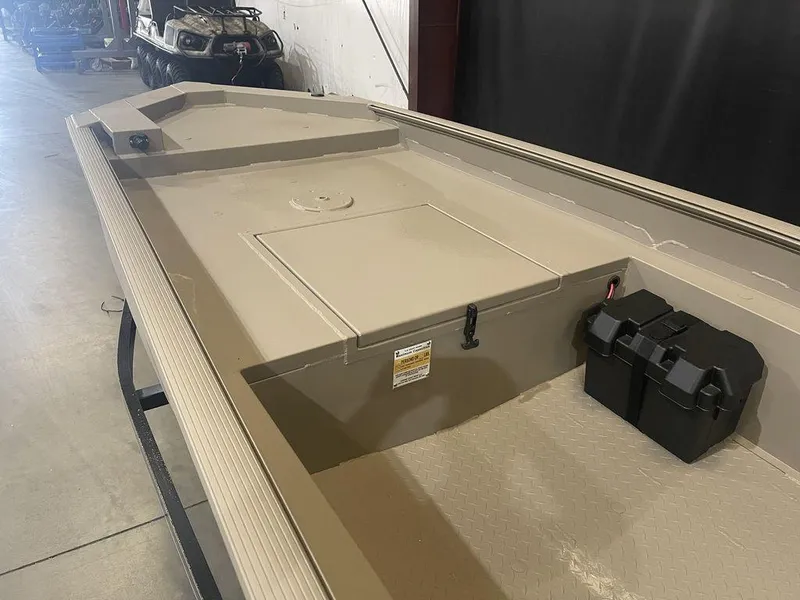 Slide: The Image of 2023 Legend Craft Bandit 1548SS Mid Deck boat interior in a warehouse. - 10