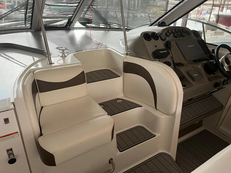 Slide: The Image of 2008 Cruisers Yachts 390 Sports Coupe helm with beige seating and modern dashboard controls. - 15