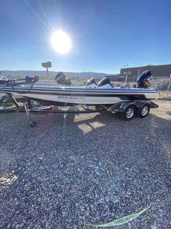 Slide: The Image of 2006 Skeeter Bass Boat in sunlight on gravel lot. - 6