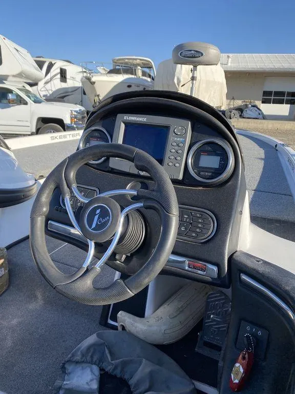 Slide: The Image of 2006 Skeeter Bass Boat dashboard with steering wheel and Lowrance fishfinder. - 7
