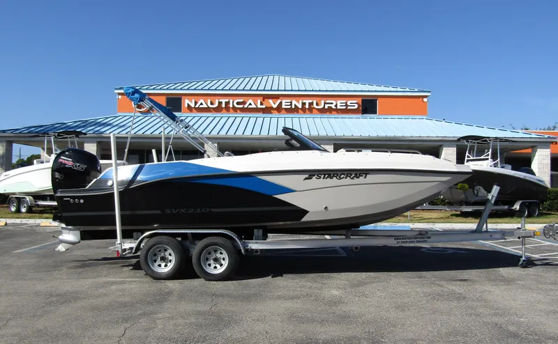 Slide: The Image of 2023 Starcraft SVX 210 OB boat on trailer at Nautical Ventures dealership. - 0