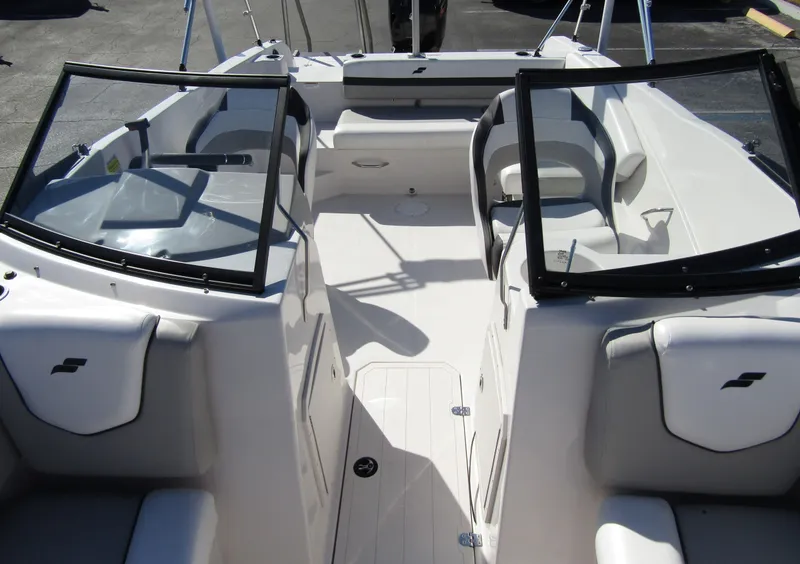 Slide: The Image of 2023 Starcraft SVX 210 OB boat interior with open windshield and seating. - 14