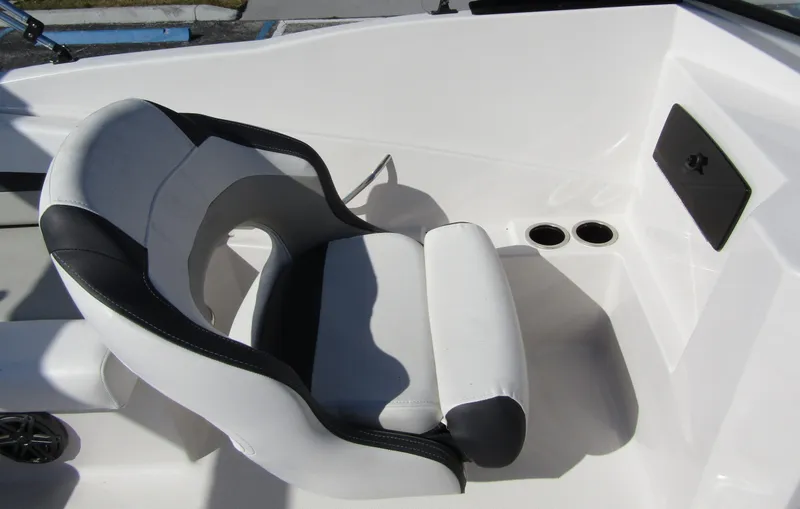 Slide: The Image of 2023 Starcraft SVX 210 OB boat interior with white and black captain's chair. - 18