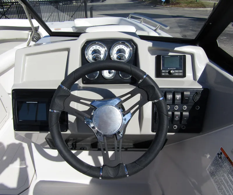 Slide: The Image of 2023 Starcraft SVX 210 OB boat dashboard with steering wheel and control panel. - 20