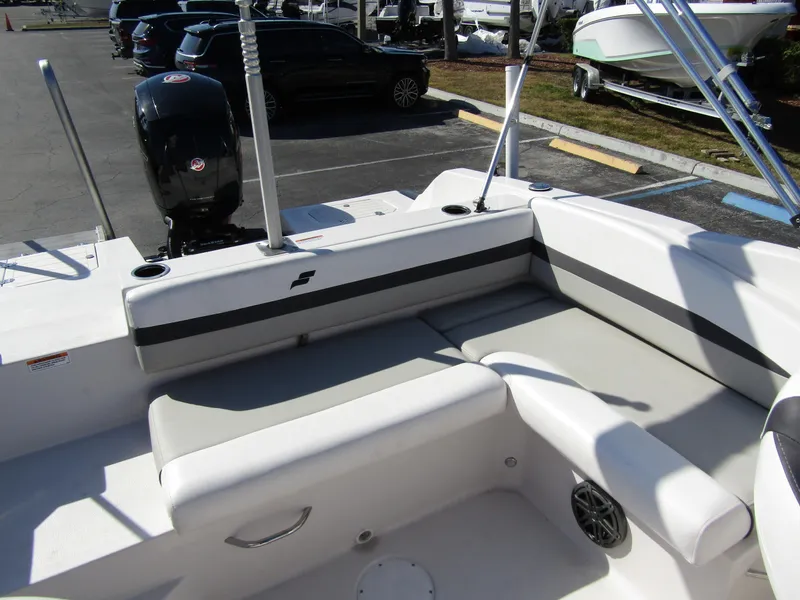 Slide: The Image of 2023 Starcraft SVX 210 OB boat interior with cushioned seating and outboard motor. - 25