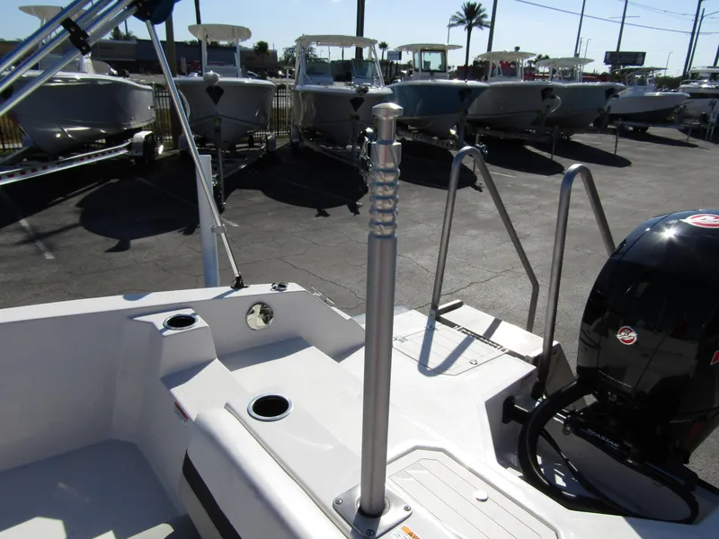 Slide: The Image of 2023 Starcraft SVX 210 OB boat interior with motor and seating area. - 27
