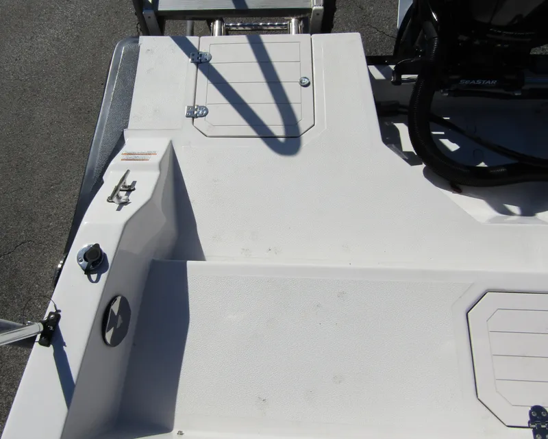 Slide: The Image of 2023 Starcraft SVX 210 OB boat deck with storage compartments and ladder. - 30