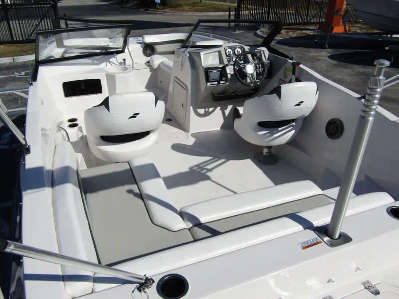 Slide: The Image of 2023 Starcraft SVX 210 OB boat interior with white seating and modern dashboard. - 32