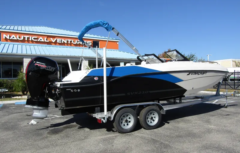 Slide: The Image of 2023 Starcraft SVX 210 OB boat on a trailer outside Nautical Ventures. - 6
