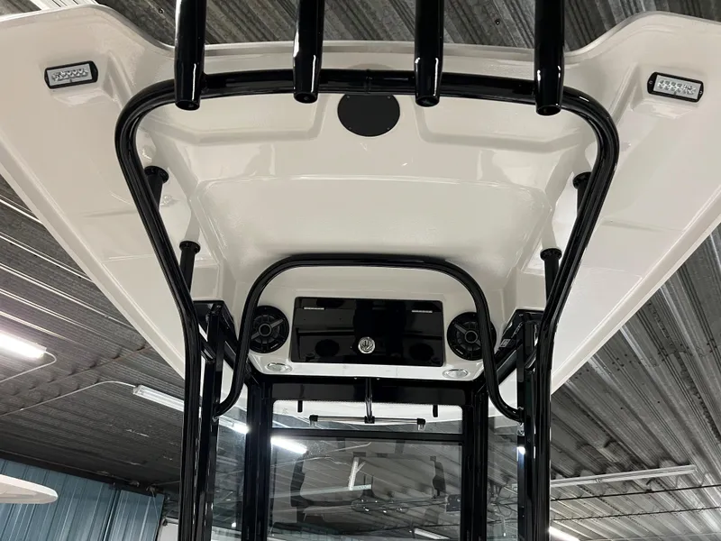 Slide: The Image of 2023 Robalo 266 Cayman T-top with black frame and integrated speakers. - 13