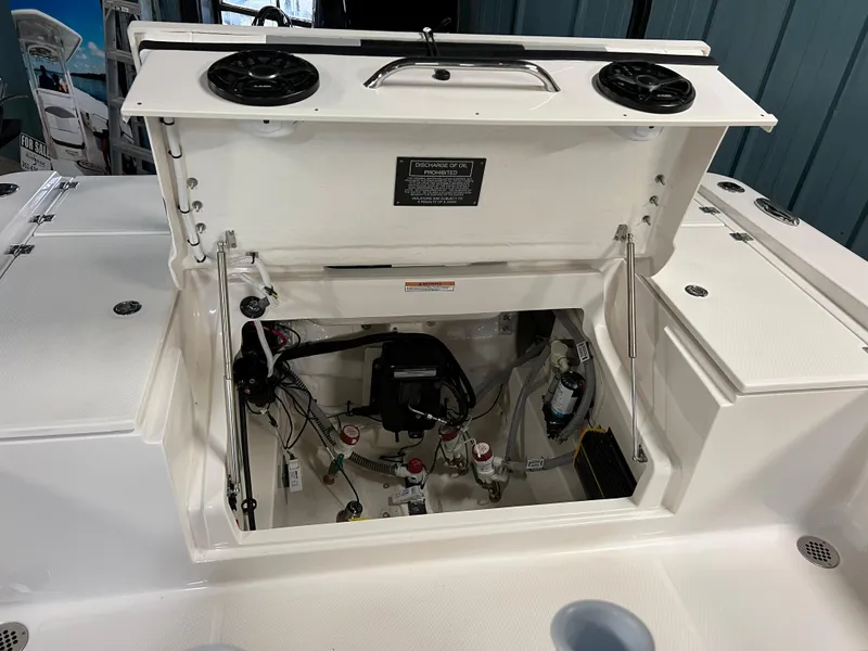 Slide: The Image of 2023 Robalo 266 Cayman boat storage compartment with open hatch. - 16