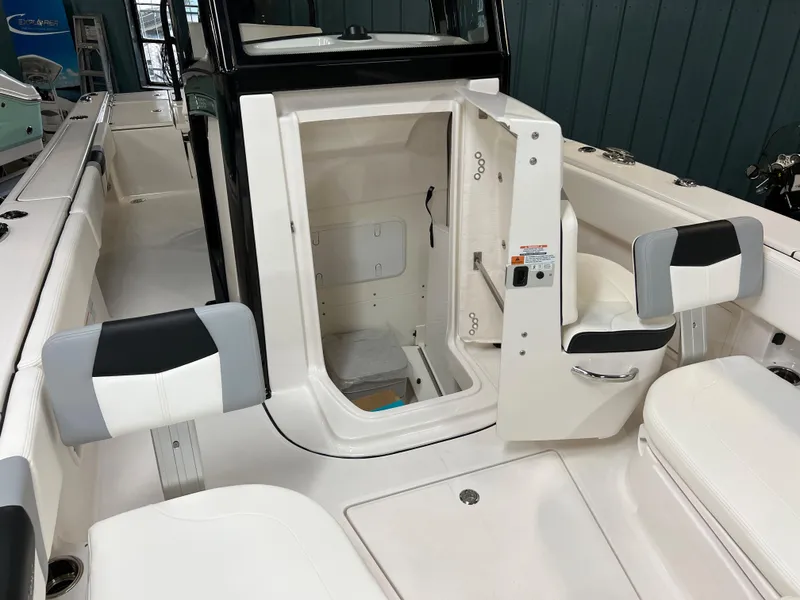 Slide: The Image of 2023 Robalo 266 Cayman boat interior with open storage compartment. - 19