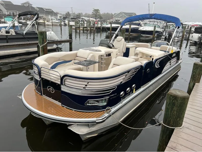 The Image of 2013 Avalon AMBASSADOR 2785 ENTERTAINER pontoon boat docked at marina. - 1