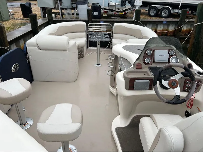 Slide: The Image of 2013 Avalon AMBASSADOR 2785 ENTERTAINER boat interior with seating and control console. - 17