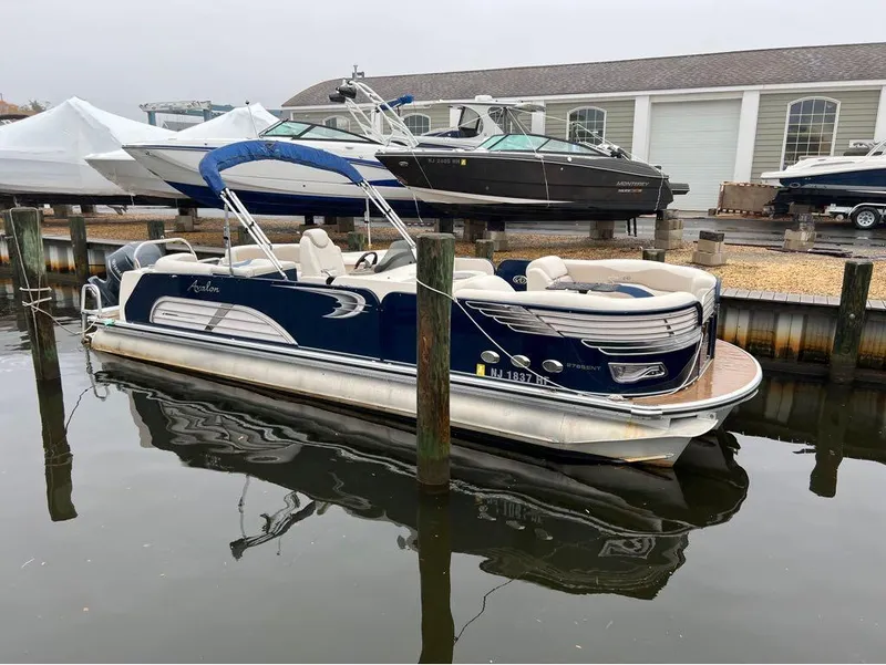 Slide: The Image of 2013 Avalon AMBASSADOR 2785 ENTERTAINER pontoon boat docked in a marina. - 8