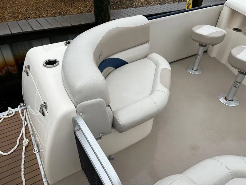 Slide: The Image of 2013 Avalon AMBASSADOR 2785 ENTERTAINER boat interior with cushioned seating and cup holders. - 9