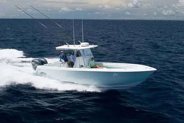 The Image of 2025 Contender 35 ST boat on trailer, parked roadside with palm trees. - 0