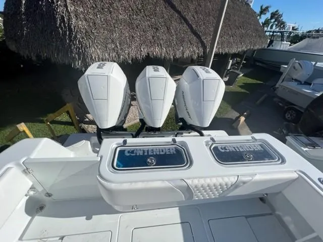 Slide: The Image of 2025 Contender 35 ST boat with triple outboard engines, rear view. - 10