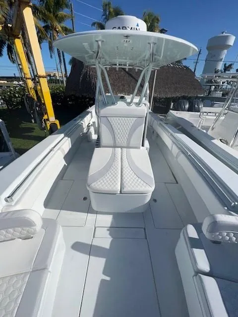 Slide: The Image of 2025 Contender 35 ST boat with sleek white seating and modern design. - 14