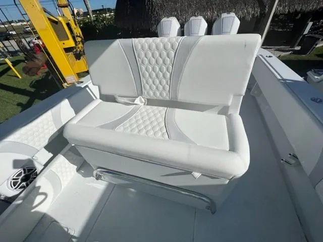 Slide: The Image of 2025 Contender 35 ST boat with white cushioned seating and modern design. - 16