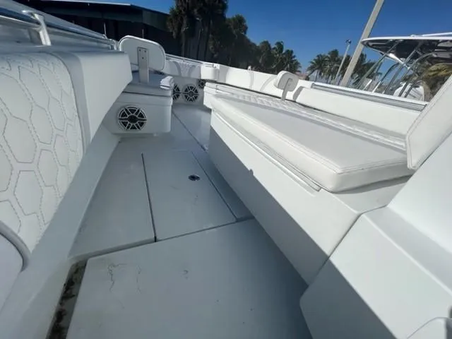 Slide: The Image of 2025 Contender 35 ST boat interior with white seating and speakers. - 19