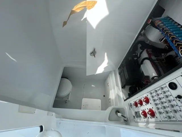 Slide: The Image of 2025 Contender 35 ST boat interior with control panel and compact toilet. - 20