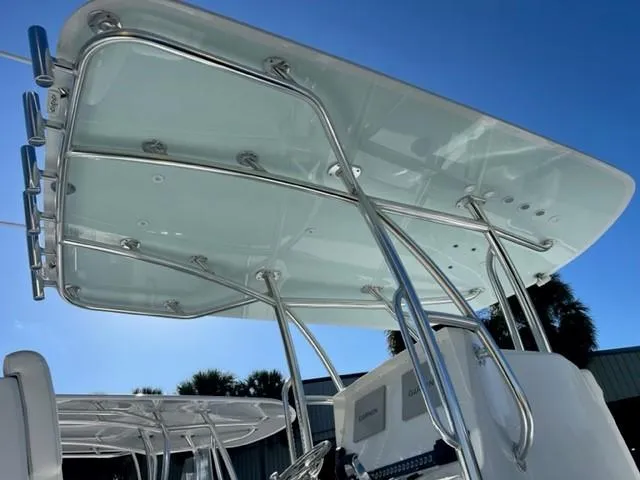 Slide: The Image of 2025 Contender 35 ST boat with sleek T-top design under clear blue sky. - 24