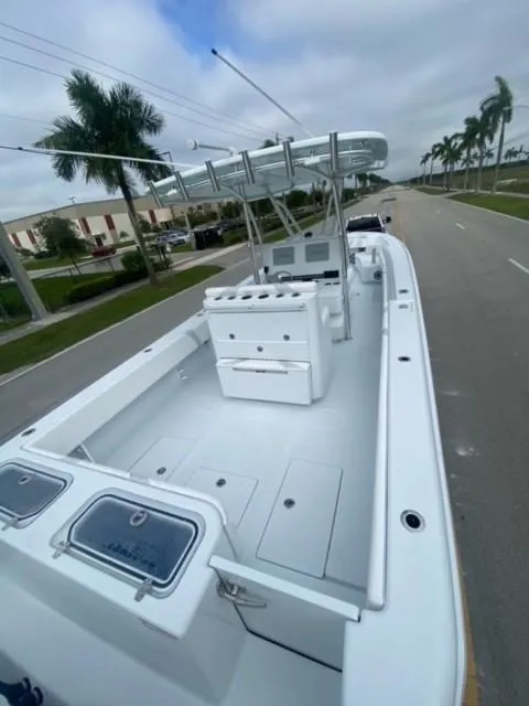 Slide: The Image of 2025 Contender 35 ST boat with spacious deck and modern design on a road. - 7