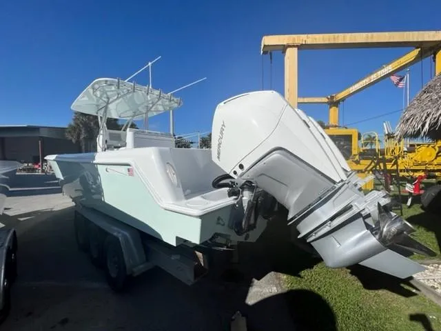 Slide: The Image of 2025 Contender 35 ST boat with powerful outboard engine in a sunny marina setting. - 8