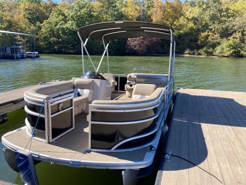 Slide: The Image of 2013 Cypress Cay Cabana 200 pontoon boat docked on a sunny lake. - 2