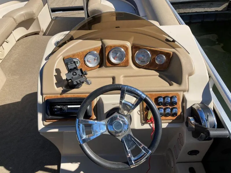 Slide: The Image of Steering console of 2013 Cypress Cay Cabana 200 pontoon boat with gauges and controls. - 3
