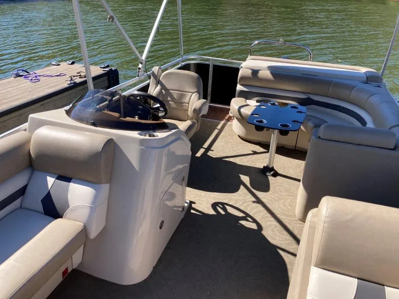 Slide: The Image of 2013 Cypress Cay Cabana 200 pontoon boat interior with seating and steering wheel. - 4