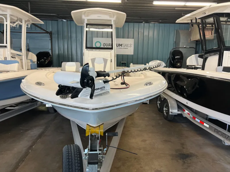 Slide: The Image of 2023 Robalo 246 Cayman boat on trailer in showroom. - 1
