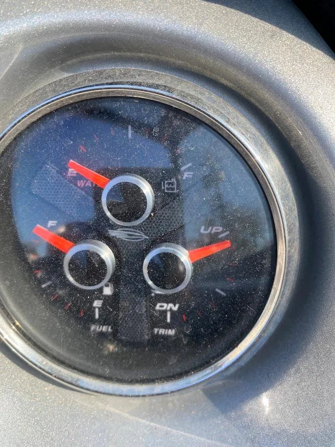 Slide: The Image of Close-up of 2016 Chaparral 224 Sunesta boat fuel and trim gauge. - 10