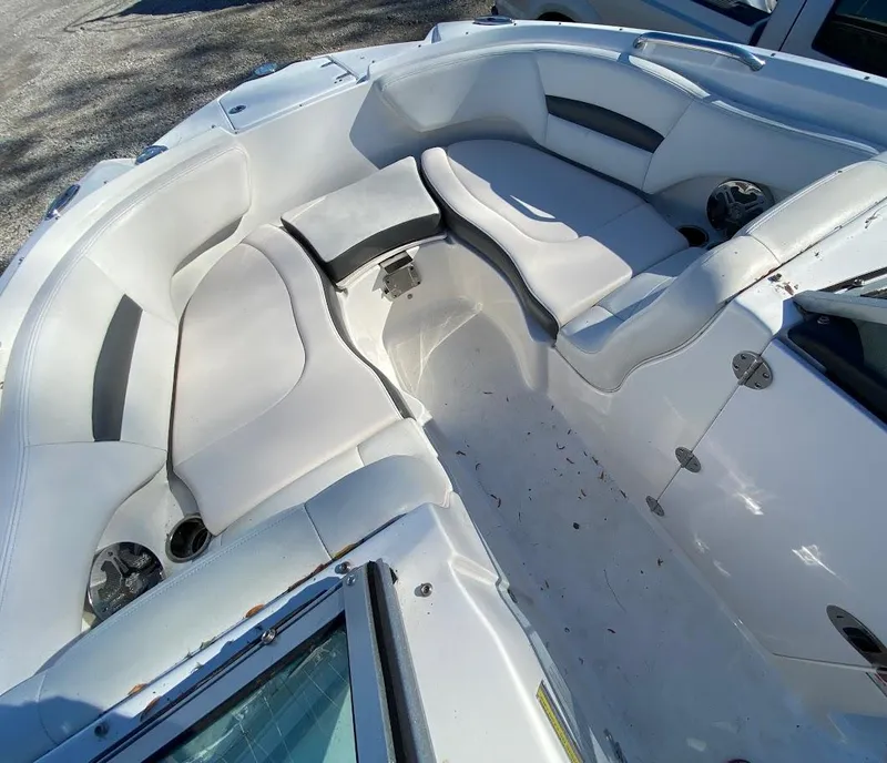 Slide: The Image of 2016 Chaparral 224 Sunesta boat interior with white seating and cup holders. - 12