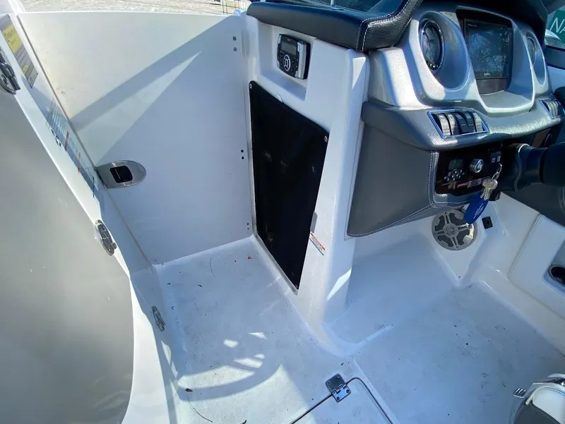 Slide: The Image of Interior cockpit of a 2016 Chaparral 224 Sunesta boat, featuring steering controls and dashboard. - 15