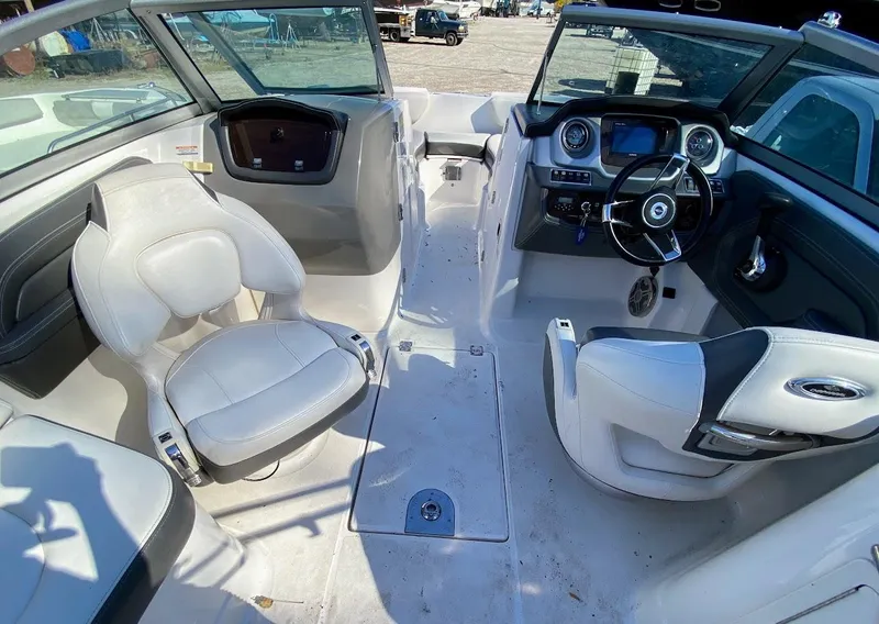 Slide: The Image of 2016 Chaparral 224 Sunesta boat interior with white seating and modern dashboard. - 18