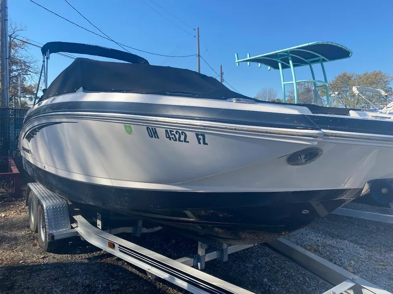 Slide: The Image of 2016 Chaparral 224 Sunesta boat on trailer with cover, side view. - 2