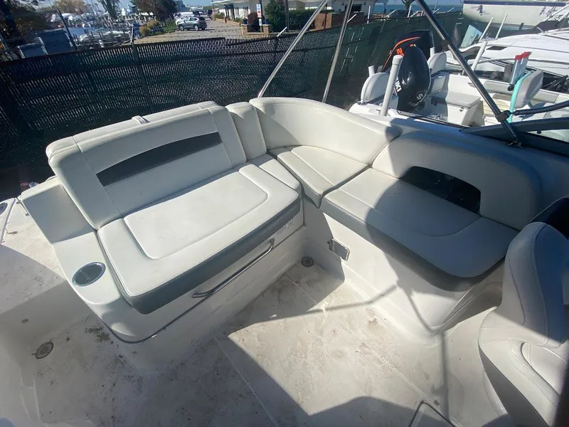 Slide: The Image of 2016 Chaparral 224 Sunesta boat interior with white seating and cup holder. - 23