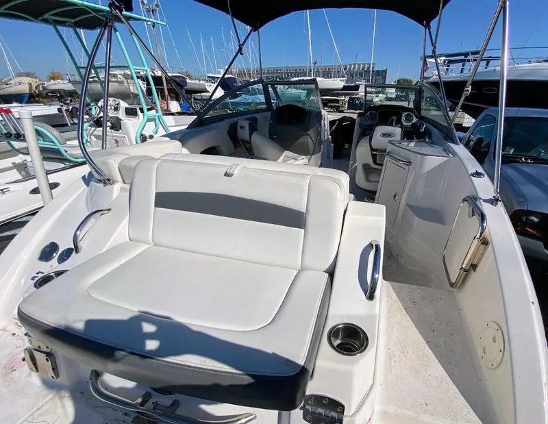 Slide: The Image of 2016 Chaparral 224 Sunesta boat interior with white seating and dashboard. - 25