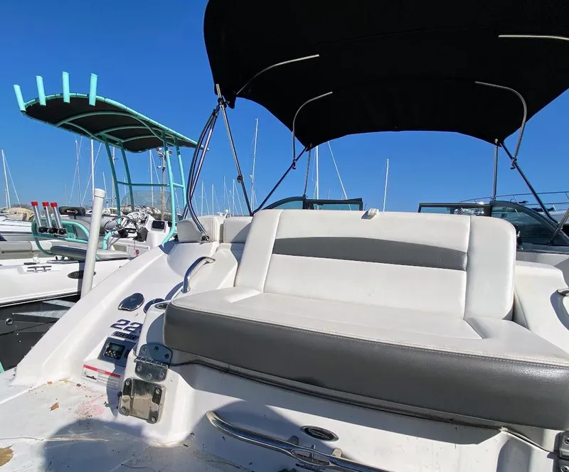 Slide: The Image of 2016 Chaparral 224 Sunesta boat with seating and canopy in a marina. - 27