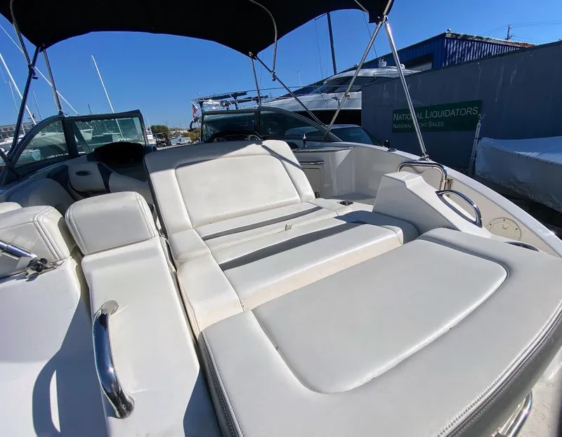 Slide: The Image of 2016 Chaparral 224 Sunesta boat with white seating and black canopy. - 28