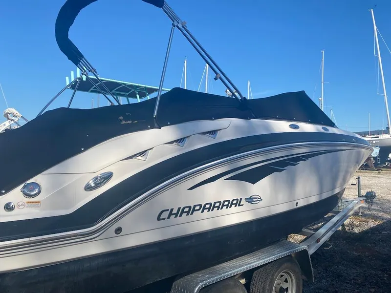 Slide: The Image of 2016 Chaparral 224 Sunesta boat on a trailer with a black cover. - 3