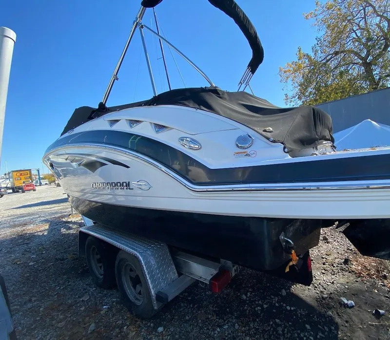 Slide: The Image of 2016 Chaparral 224 Sunesta boat on a trailer, covered and parked outdoors. - 4